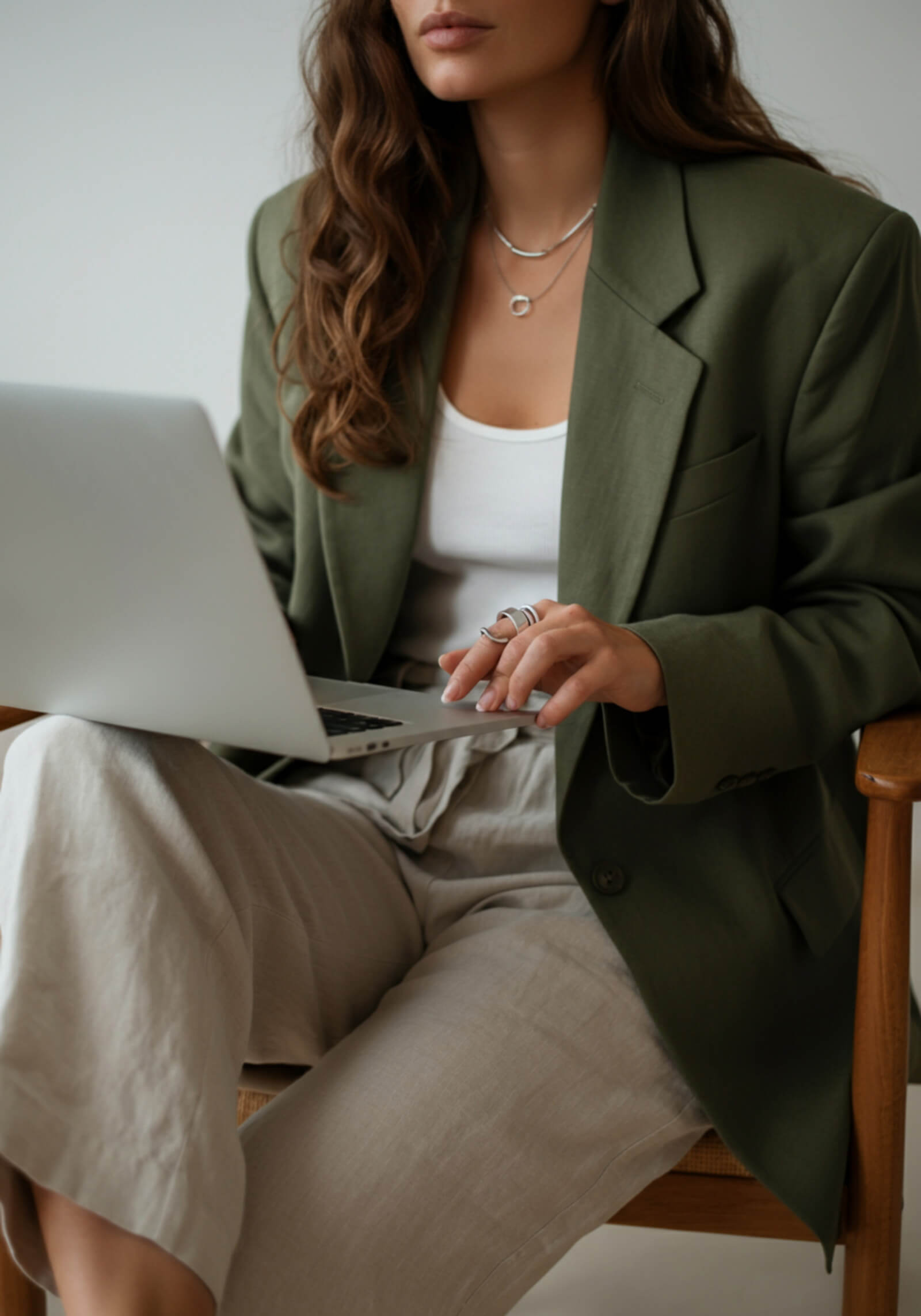 Female photographer working on her laptop, editing her photography website and making updates.