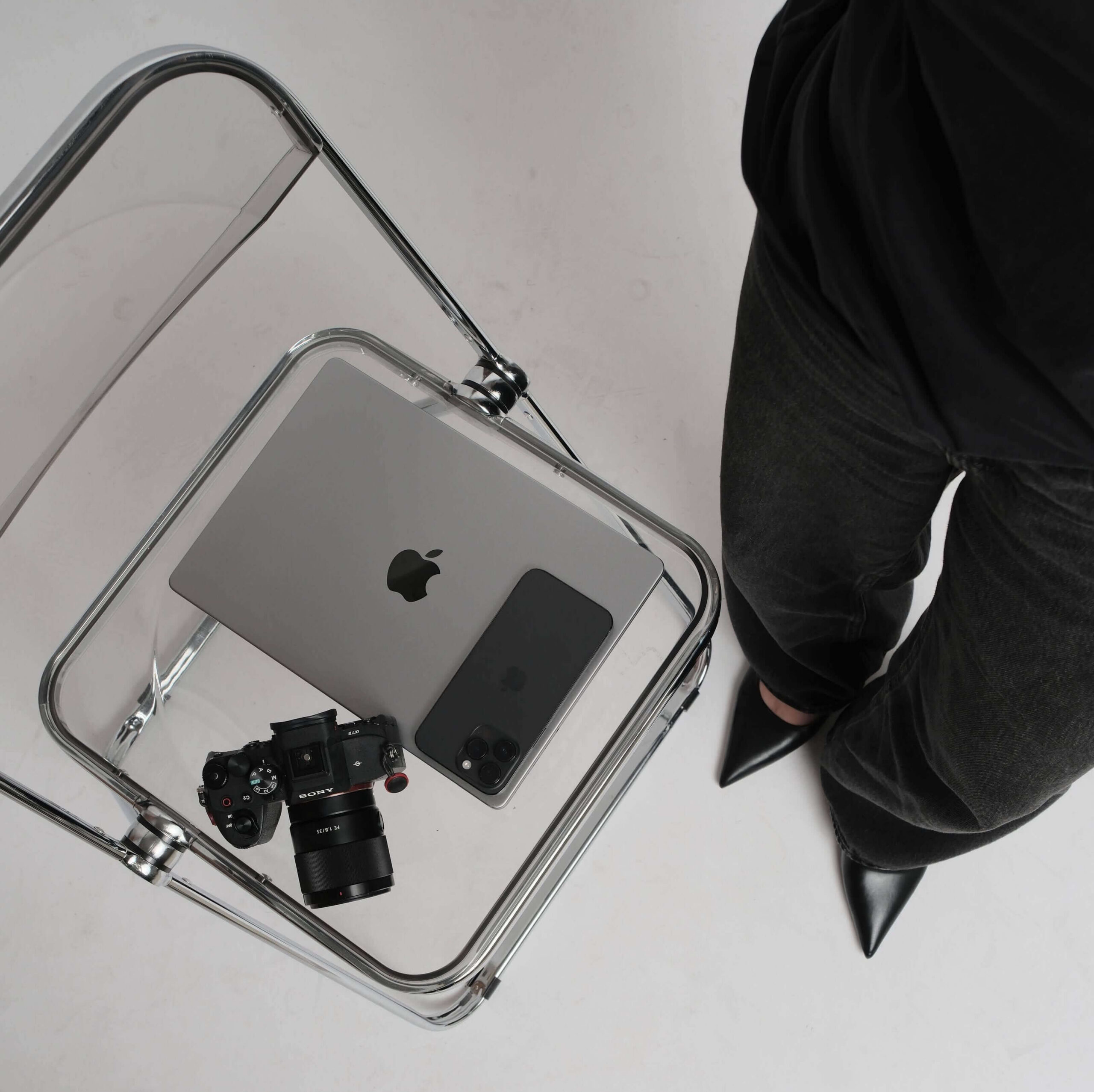 Wedding photographer website must haves — Sony camera, MacBook and iPhone on a clear acrylic chair